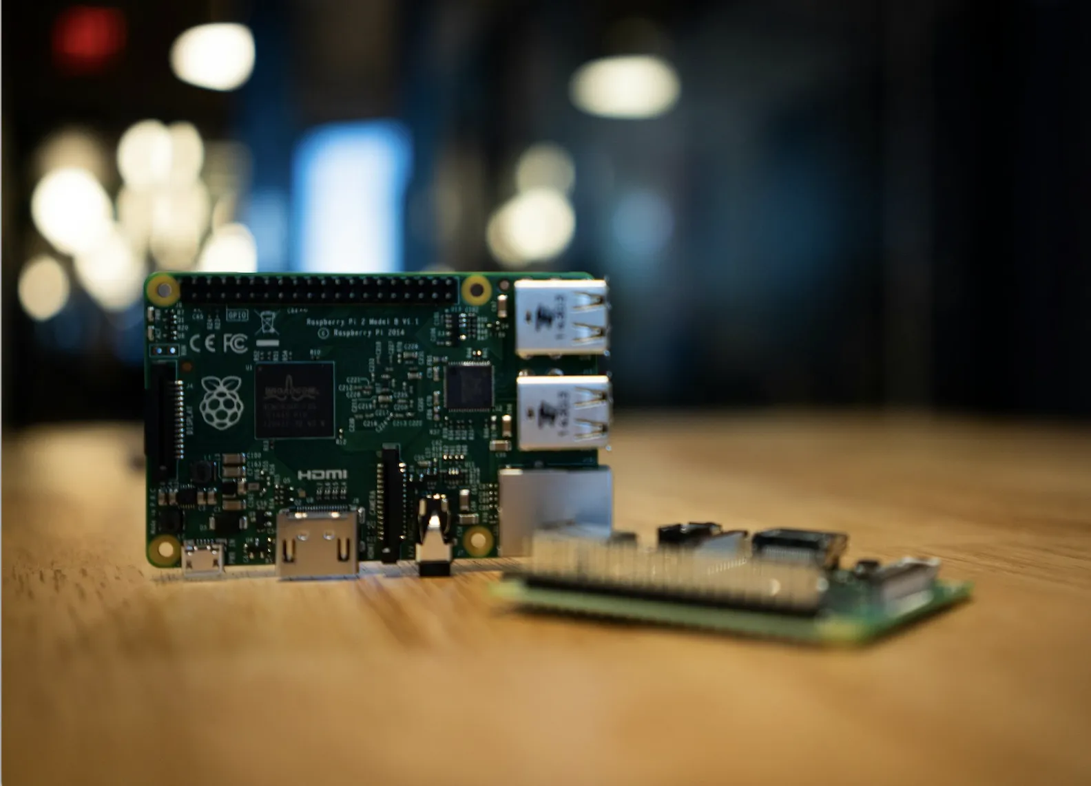 Микрокомпьютер Raspberry Pi на деревянном столе крупным планом